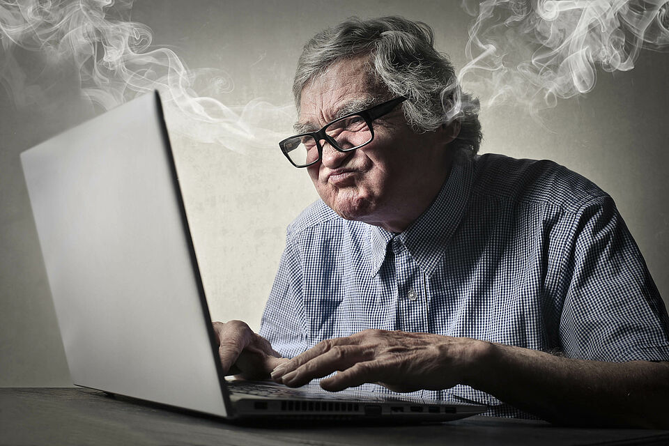 Angry businessman working at pc